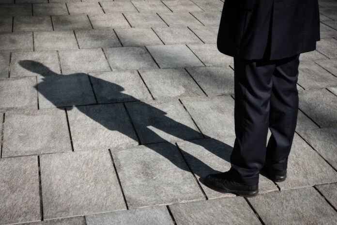 Floor,With,Shadow,Of,A,Businessman,Standing