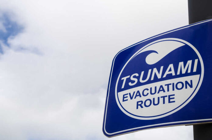 Copy,Space,Of,Tsunami,Evacuation,Route,Sign,On,White,Clouds