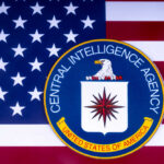 CIA emblem on American flag background.