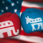 Red Republican glove and blue Democrat glove facing off.