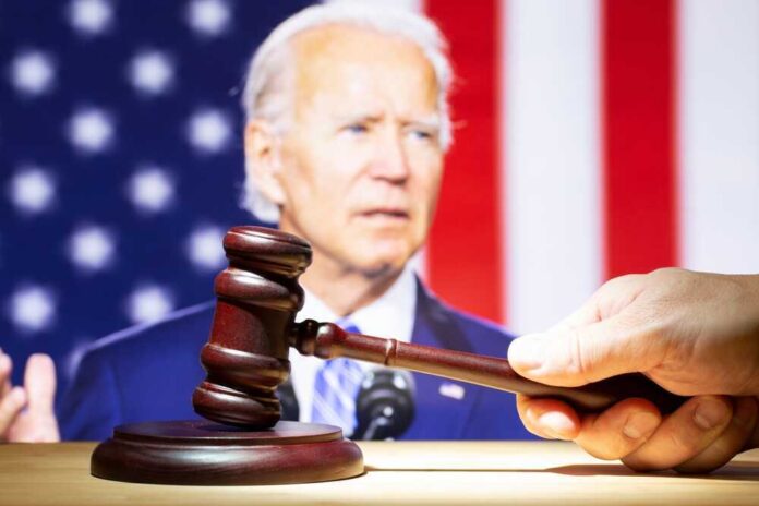 shutterstock_2400282329.jpg featured image Joe Biden with a hand holding a gavel