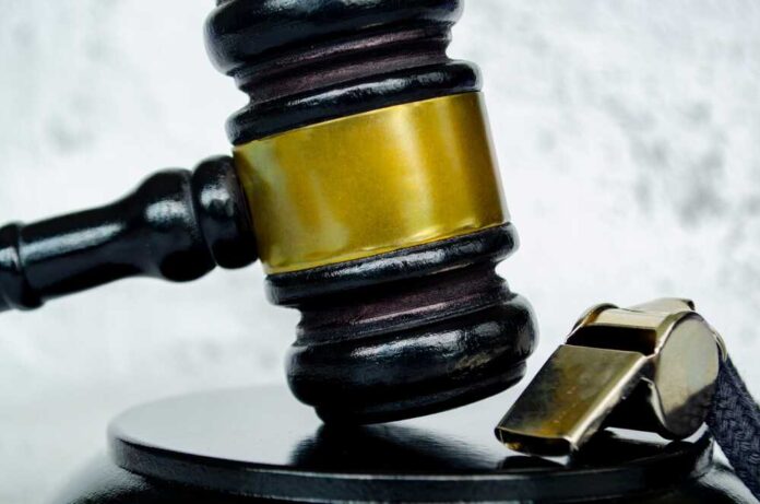 shutterstock_2596527751.jpg featured image Gavel and whistle on gray background close up