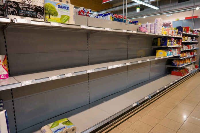 shutterstock_1663611619.jpg featured image Empty supermarket shelves with sparse products displayed