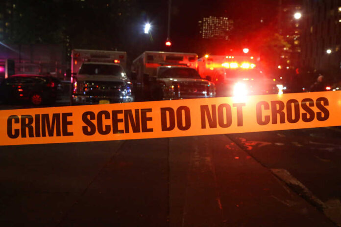 shutterstock_746018290.jpg featured image Crime scene tape with emergency vehicles in background.