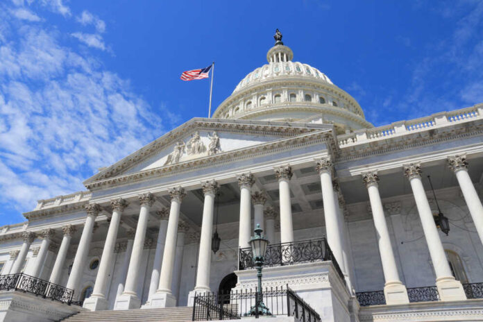 shutterstock_1122138182.jpg featured image US Capitol building with American flag and columns