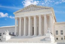 United States Supreme Court building with statues and columns.