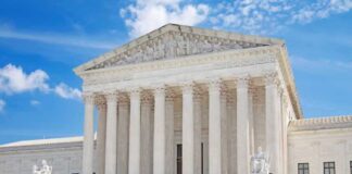 United States Supreme Court building with statues and columns.