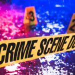 Teen Dead, 6 Injured After Mass Shooting Crime scene tape with blurred evidence markers.