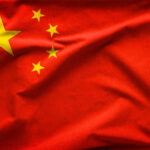 Chinese flag with five yellow stars.