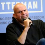 John Fetterman holding microphone.