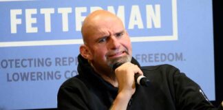 John Fetterman holding microphone.