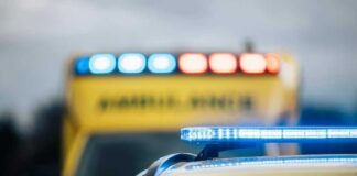 Ambulances with flashing lights on emergency scene.