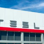 Tesla building with logo against blue sky