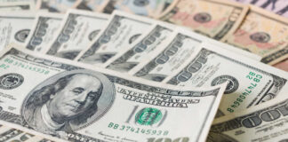 Stacks of various U.S. dollar bills.