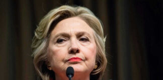 Hillary Clinton behind microphones