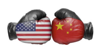 American and Chinese flag boxing gloves facing off