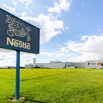 Nestle sign and factory building with cloudy sky