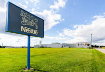 Nestle sign and factory building with cloudy sky