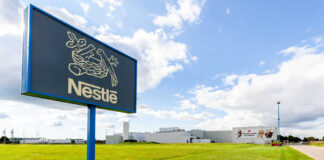 Nestle sign and factory building with cloudy sky