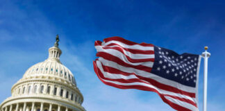 US Capitol building with American flag waving