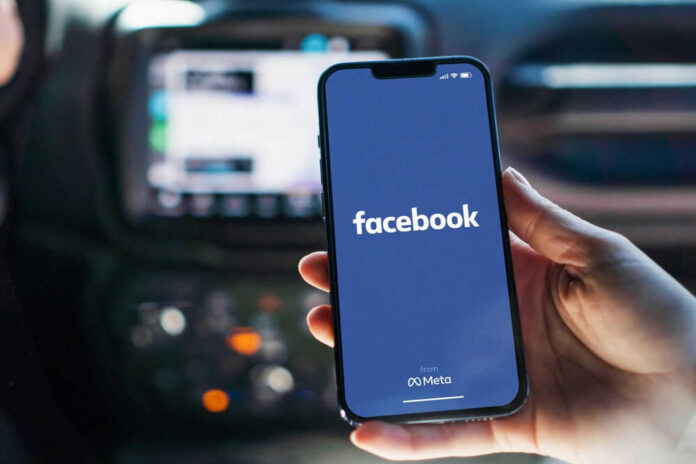 shutterstock_2197003409.jpg Phone displaying Facebook app in a car