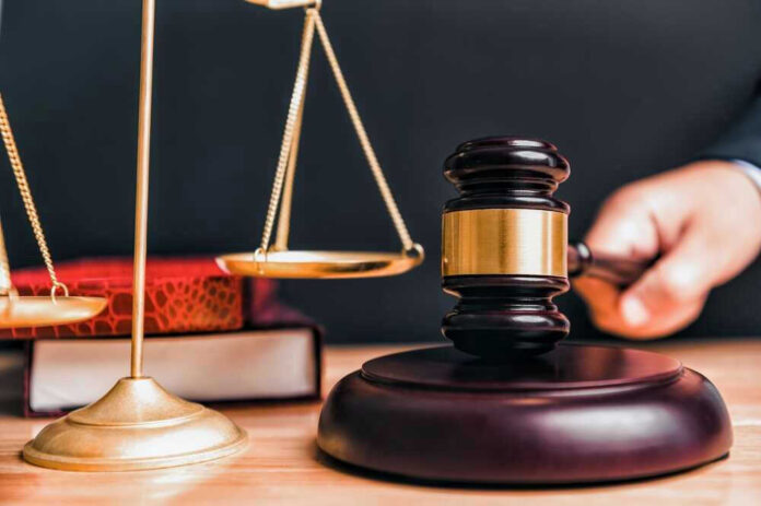 shutterstock_2314599993.jpg Judge gavel, scales of justice, and law books