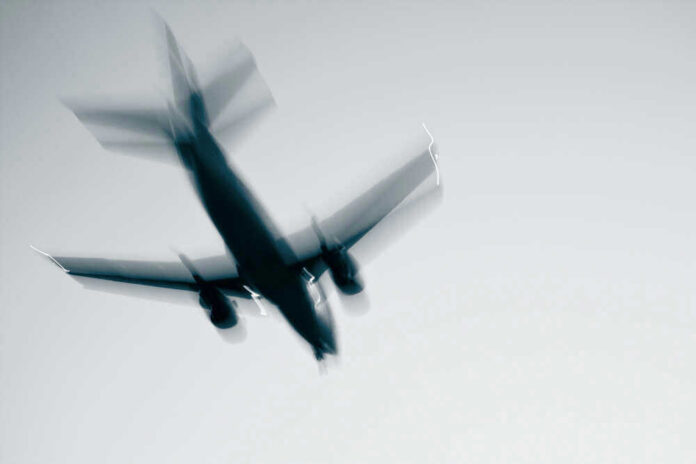 shutterstock_87563047.jpg Airplane in flight with motion blur
