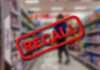 Recall stamp on blurred store aisle background
