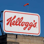 Kellogg's logo displayed on a large sign against a clear blue sky