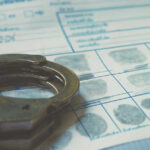Handcuffs on a fingerprint document