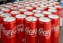 Coca-Cola cans stacked on a surface.