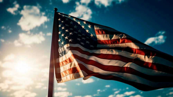 American flag waving against a bright sky