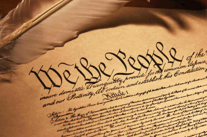 U.S. Constitution We the People with feather quill.