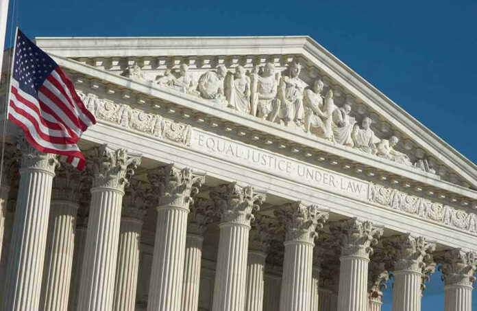 US Supreme Court building facade with flag