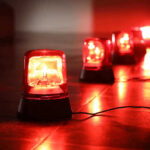 Red emergency lights on dark floor, illuminating the area