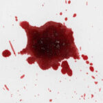 Red liquid splatter on a white background