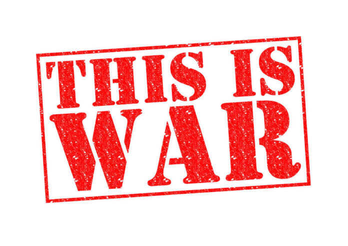 A bold red stamp with the text THIS IS WAR