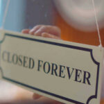 Closed forever sign being placed on window