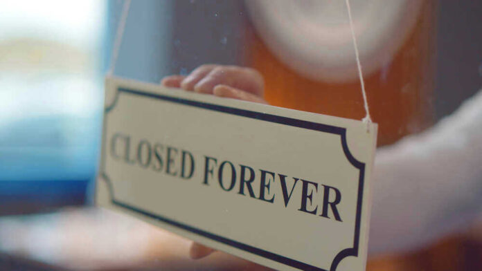 Closed forever sign being placed on window