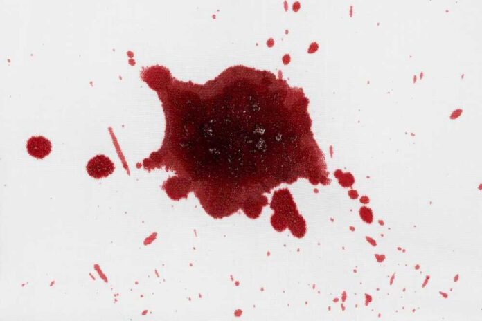 shutterstock_2439757693.jpg Red liquid splatter on a white background.