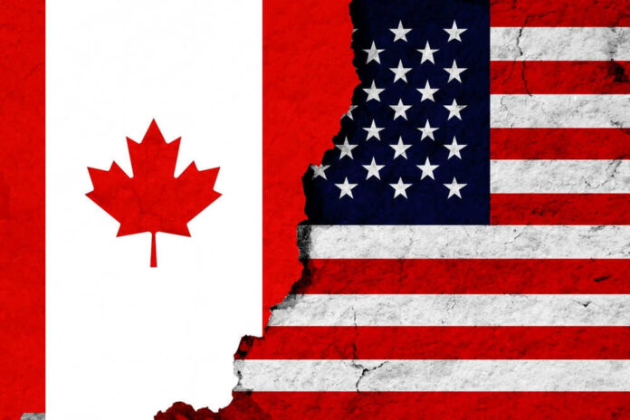 Canadian and American flags with torn dividing line