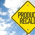Metal Fragments Found — Nationwide Recall EXPLODES Yellow product recall sign against cloudy sky