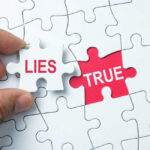 Corporate LIES Exposed — Liver Disease Bombshell A hand holding a puzzle piece labeled 'LIES' next to a piece labeled 'TRUE'