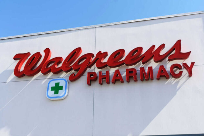 Signs for Walgreens and Pharmacy on building facade