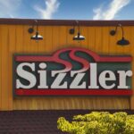 Steakhouse Triumph: Sizzler Is Back!! Sizzler restaurant sign against a blue sky