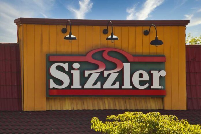 Sizzler restaurant sign against a blue sky