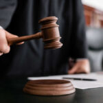 Judge’s “Act of War” Ruling Stuns DC Judge holding gavel in courtroom.