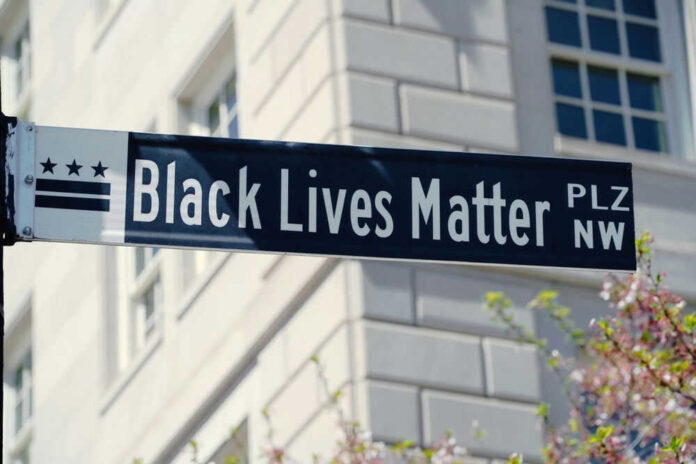 Black Lives Matter street sign against building background