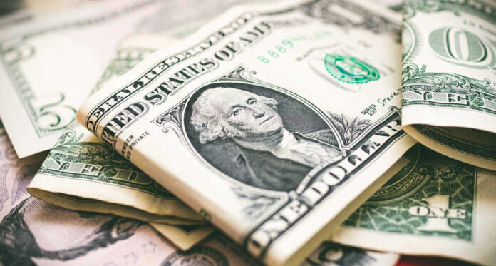 U.S. dollar bills with George Washington visible.