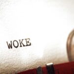 Trump ERASES Woke Cemetery Panels Close-up of the word WOKE typed on paper from a typewriter